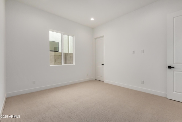 unfurnished room with light carpet, baseboards, and recessed lighting