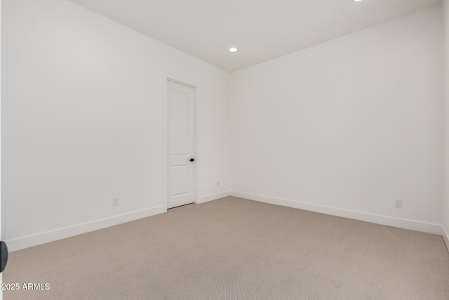 spare room featuring light carpet, baseboards, and recessed lighting