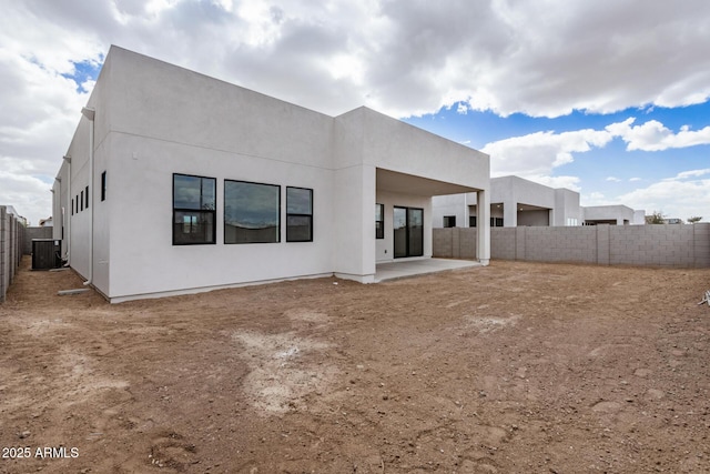 back of property featuring cooling unit, a fenced backyard, a patio, and stucco siding