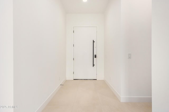 hallway featuring baseboards and recessed lighting