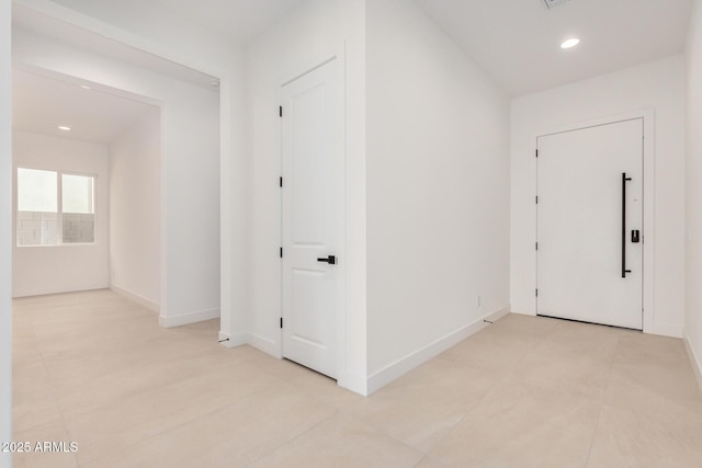 corridor featuring visible vents, baseboards, and recessed lighting