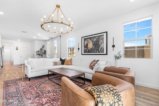 living room with light hardwood / wood-style floors and a chandelier