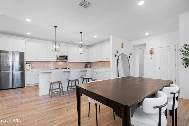 dining area featuring light wood-type flooring