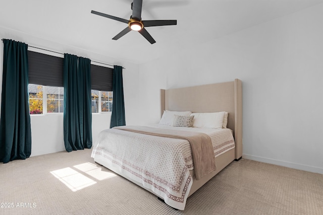 bedroom with ceiling fan and light carpet