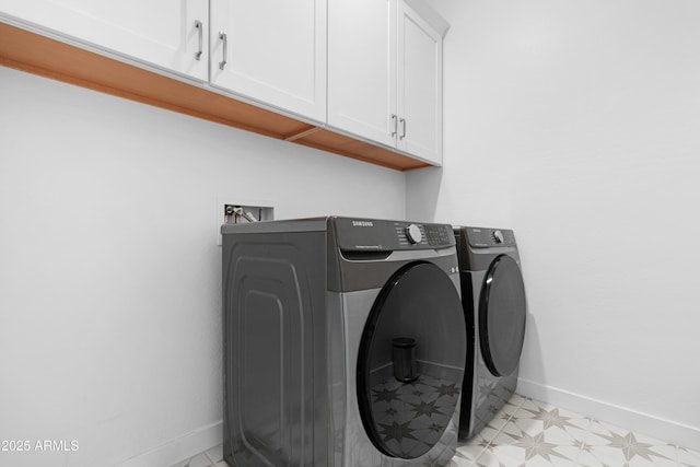 washroom featuring washer and dryer and cabinets