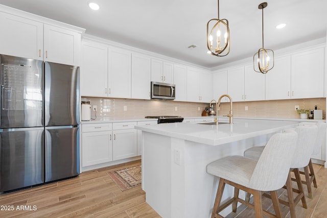 kitchen featuring sink, white cabinetry, and appliances with stainless steel finishes