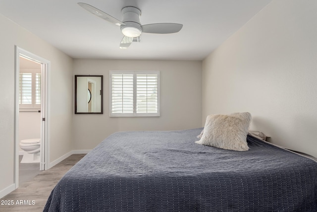 bedroom with light wood finished floors, ceiling fan, baseboards, and ensuite bathroom