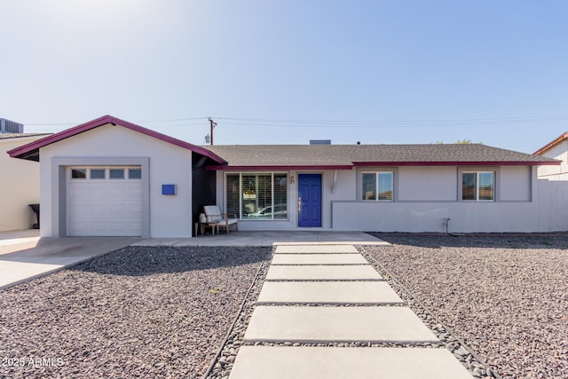 ranch-style home with a garage, driveway, and stucco siding