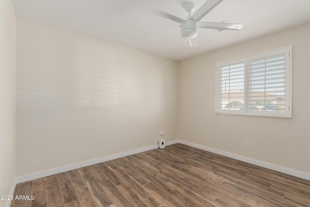 spare room with a ceiling fan, baseboards, and wood finished floors