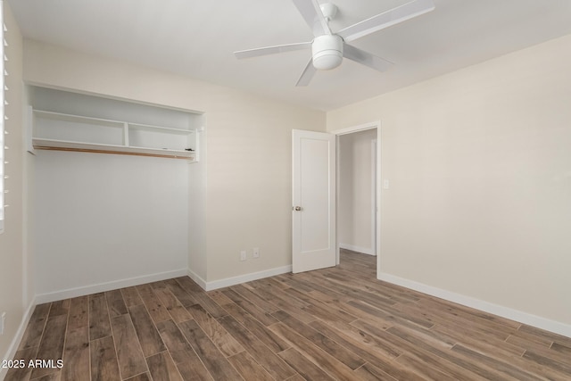 unfurnished bedroom featuring a closet, wood finished floors, a ceiling fan, and baseboards