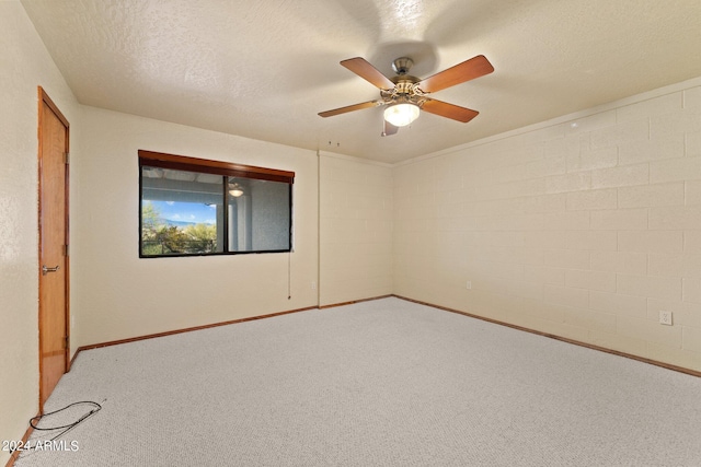 carpeted empty room featuring ceiling fan and a textured ceiling