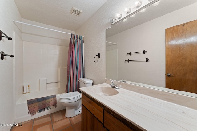 full bathroom featuring shower / bath combo, vanity, tile patterned floors, toilet, and a textured ceiling