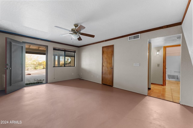 empty room with ceiling fan, crown molding, and a textured ceiling