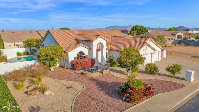 view of front of property with driveway, a fenced in pool, a tile roof, an attached garage, and stucco siding