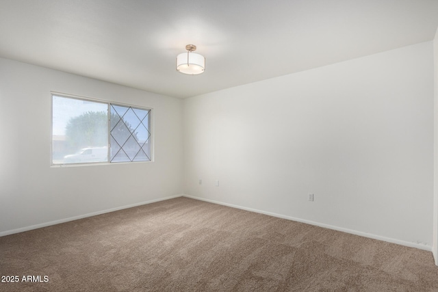 empty room with baseboards and carpet flooring
