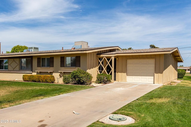 single story home with a front yard, a garage, and driveway