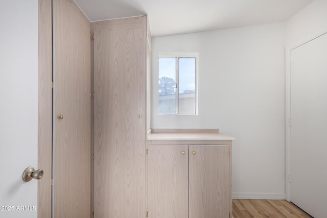 interior space with light wood finished floors and baseboards