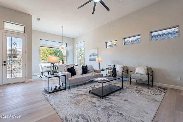 living room with ceiling fan and light hardwood / wood-style flooring