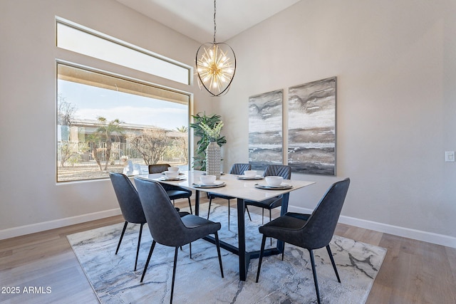 dining space featuring hardwood / wood-style floors and a chandelier