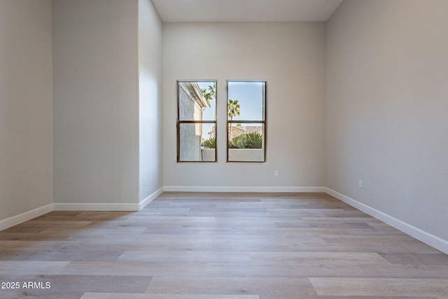 empty room with light hardwood / wood-style flooring