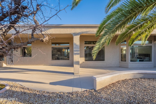 back of property with a patio