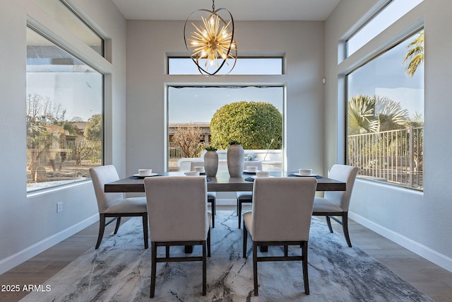 dining room with a notable chandelier and wood-type flooring