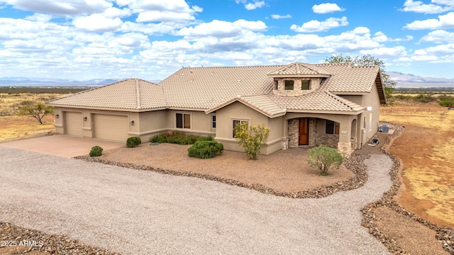 6754 E Roberto Loop, Hereford, AZ 85615 - mediterranean / spanish house featuring stucco siding, an attached garage, driveway, and a tiled roof