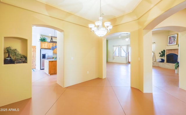 6754 E Roberto Loop, Hereford, AZ 85615 - hall with arched walkways, a chandelier, and light tile patterned floors