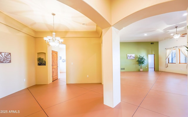 6754 E Roberto Loop, Hereford, AZ 85615 - tiled empty room featuring a chandelier, arched walkways, and ceiling fan