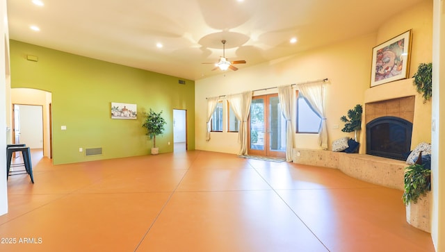 6754 E Roberto Loop, Hereford, AZ 85615 - unfurnished living room with a ceiling fan, a tile fireplace, recessed lighting, and arched walkways