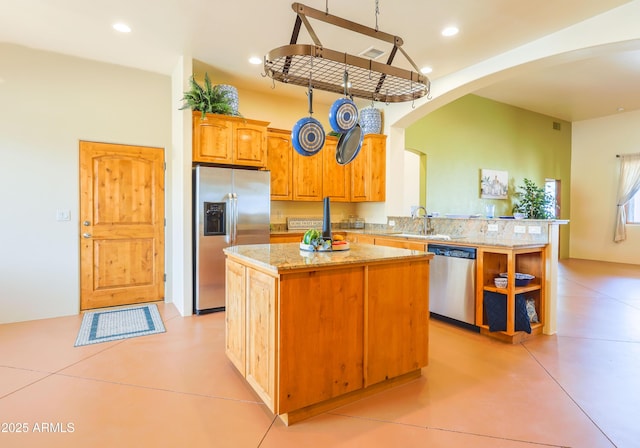 6754 E Roberto Loop, Hereford, AZ 85615 - kitchen featuring stainless steel appliances, arched walkways, a kitchen island, a peninsula, and a sink