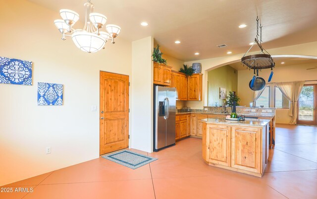 6754 E Roberto Loop, Hereford, AZ 85615 - kitchen with stainless steel refrigerator with ice dispenser, arched walkways, recessed lighting, a sink, and pendant lighting