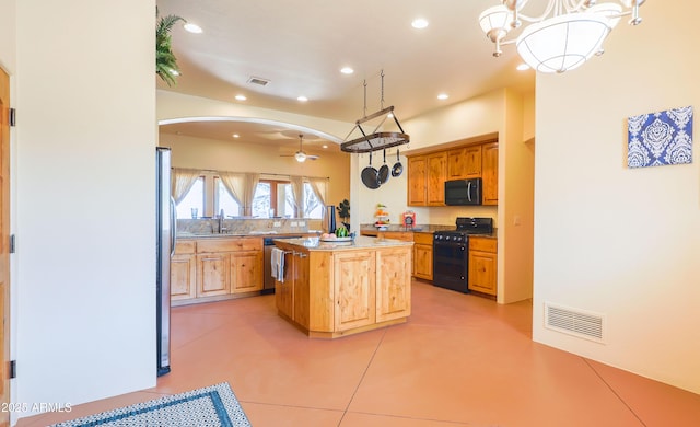 6754 E Roberto Loop, Hereford, AZ 85615 - kitchen featuring black gas range oven, a center island, ceiling fan, recessed lighting, and light countertops