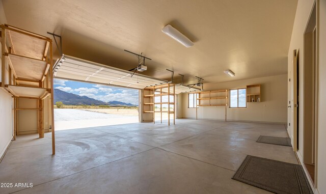 6754 E Roberto Loop, Hereford, AZ 85615 - garage with a garage door opener, a mountain view, and baseboards