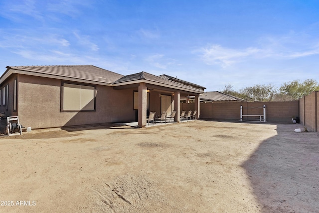 676 N 156th Ln, Goodyear, AZ 85338 - back of house featuring a tile roof, a patio area, a fenced backyard, and stucco siding