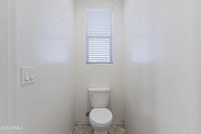 676 N 156th Ln, Goodyear, AZ 85338 - bathroom with toilet, baseboards, and tile patterned floors