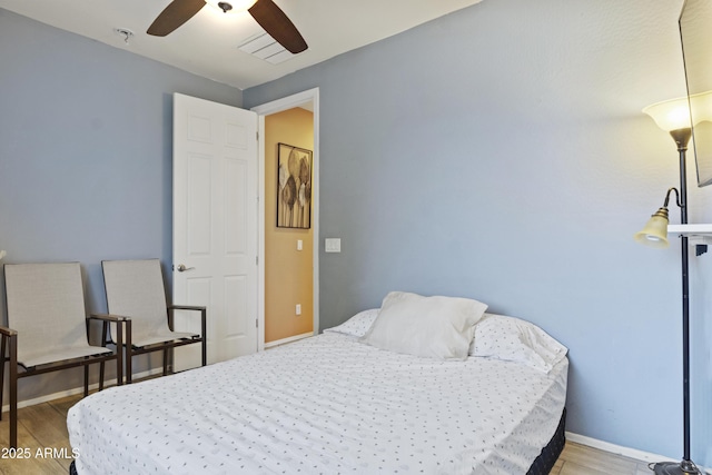 676 N 156th Ln, Goodyear, AZ 85338 - bedroom featuring a ceiling fan, baseboards, and light wood finished floors