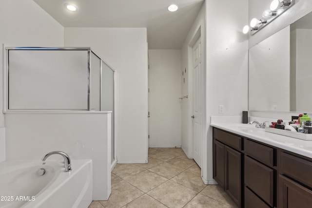676 N 156th Ln, Goodyear, AZ 85338 - full bath featuring a garden tub, tile patterned flooring, a shower stall, and vanity