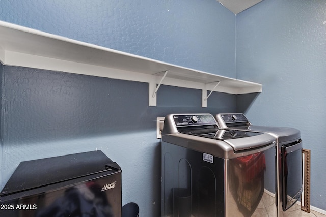676 N 156th Ln, Goodyear, AZ 85338 - laundry area featuring a textured wall, laundry area, light tile patterned flooring, and washer and dryer