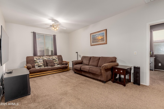 living room with ceiling fan and carpet flooring