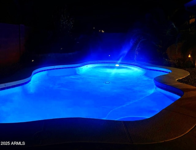 view of pool at night