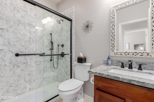 bathroom with vanity, toilet, and a shower with shower door