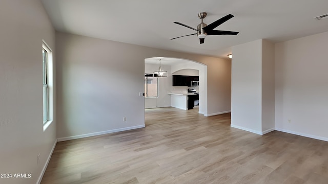 unfurnished living room featuring hardwood / wood-style floors and ceiling fan