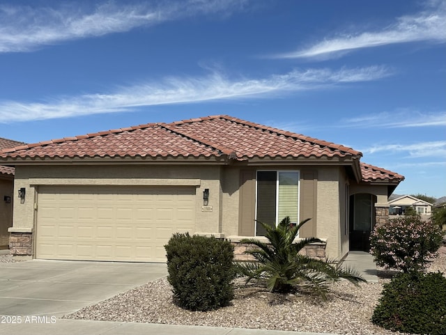 mediterranean / spanish-style home featuring a garage, a tile roof, concrete driveway, and stucco siding