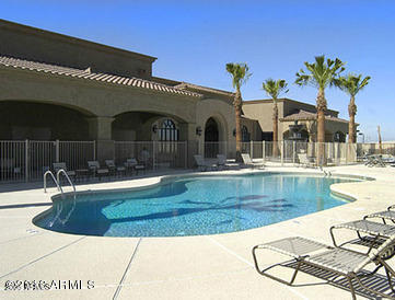 community pool featuring fence and a patio