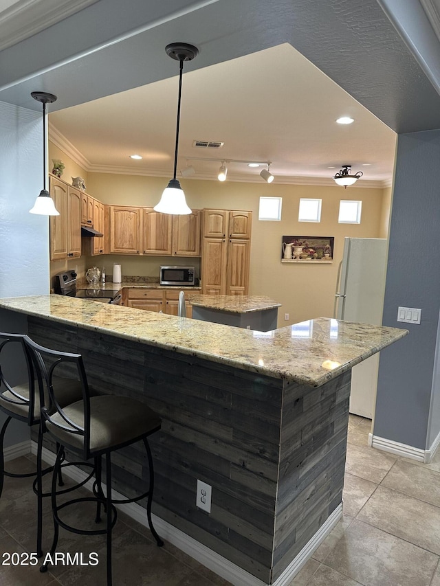 kitchen featuring appliances with stainless steel finishes, decorative light fixtures, a peninsula, light stone countertops, and crown molding