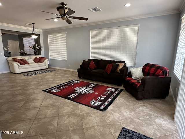 living room with baseboards, a ceiling fan, visible vents, and crown molding