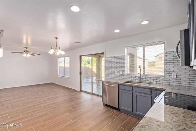 kitchen featuring sink, decorative light fixtures, gray cabinets, appliances with stainless steel finishes, and light wood-type flooring