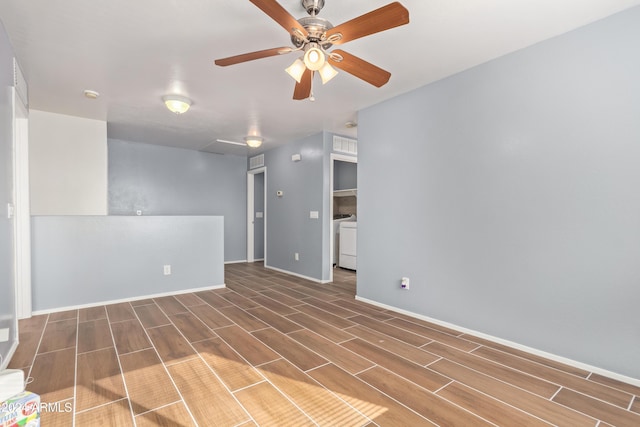 unfurnished room featuring washer / clothes dryer, ceiling fan, and dark wood-type flooring