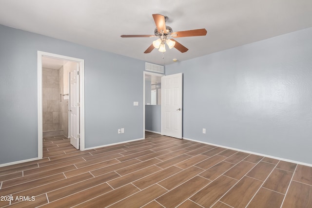 unfurnished bedroom with ensuite bathroom and ceiling fan